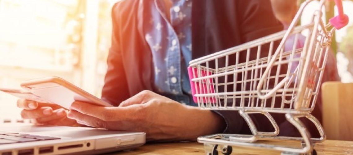 cropped-image-woman-inputting-card-information-key-phone-laptop-while-shopping-online_1423-71