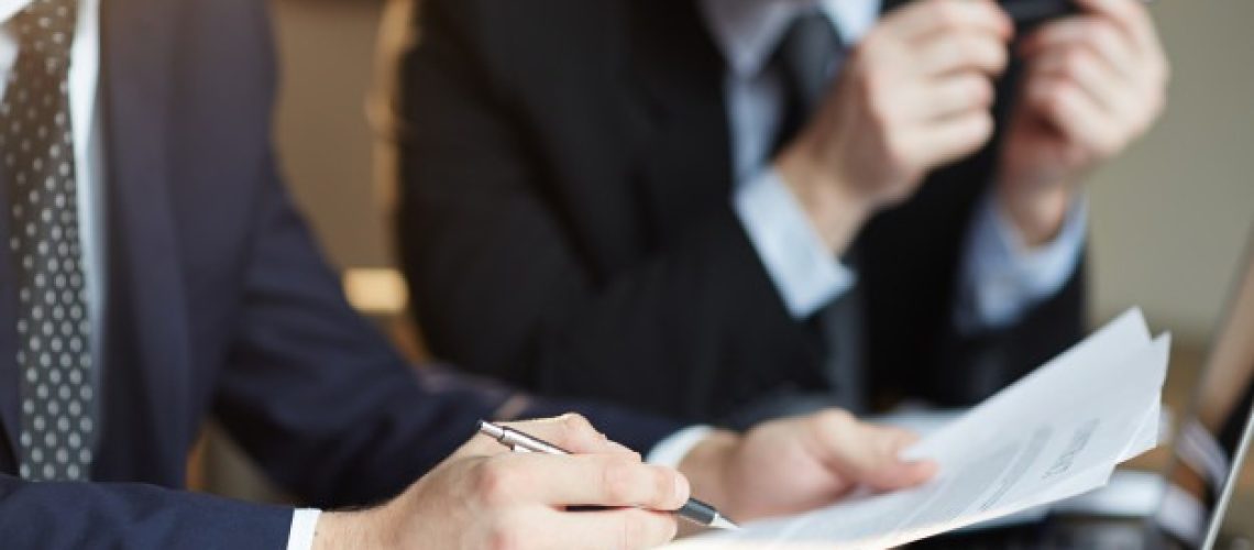 successful-business-partners-discussing-contract_1098-14790